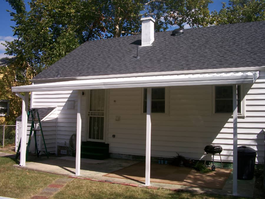 A house with a porch and roof that has been painted white.