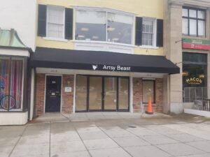 A building with windows and doors that are boarded up.