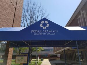 A blue tent with the name of prince georges community college on it.